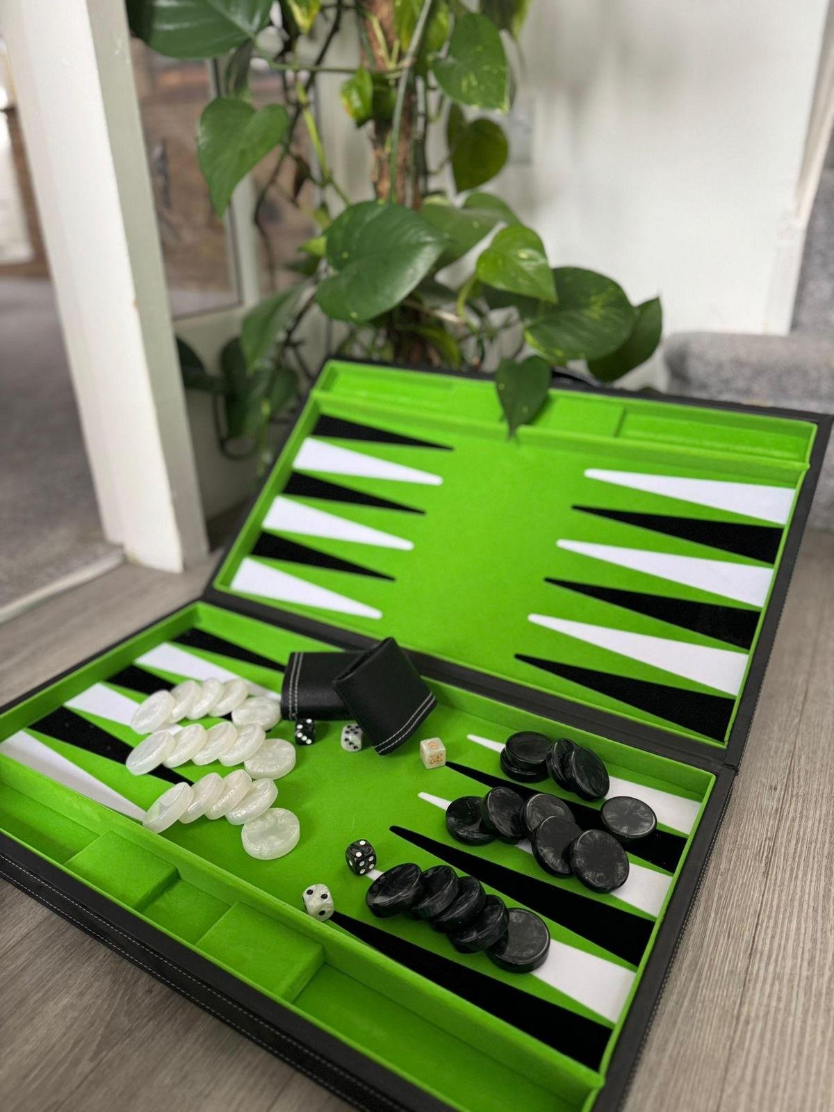 Intense backgammon players execute precise strategic moves in an elegant setting.
